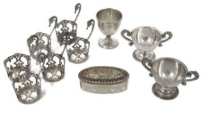 A small collection of silver comprising a silver egg cup, six silver demi-tasse holders, two