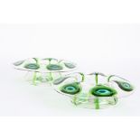 A pair of Stuart glass peacock bowls of shallow form with wide flared necks decorated with green and