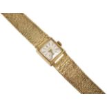 A 9ct gold ladies Tissot bracelet wristwatch. The rectangular dial with baton numerals, wind-up