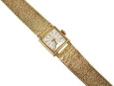 A 9ct gold ladies Tissot bracelet wristwatch. The rectangular dial with baton numerals, wind-up