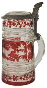 A 19th century Bohemian etched clear and ruby glass tankard decorated with a scene of a running stag