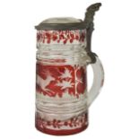 A 19th century Bohemian etched clear and ruby glass tankard decorated with a scene of a running stag