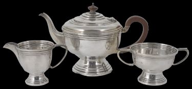 A George V Art Deco silver three piece tea set hallmarked Birmingham 1934, of banded form with