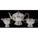 A George V Art Deco silver three piece tea set hallmarked Birmingham 1934, of banded form with