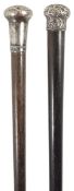 A Victorian gentleman's walking cane with scroll engraved silver top, marks rubbed, and another