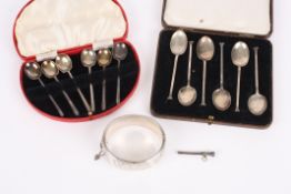 A set of six Art deco silver coffee spoons, cased, another set of silver spoons, a silver scroll