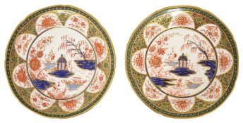 A pair of Swansea porcelain plates painted with a central Oriental scene of a fisher boy and