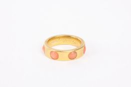 A Victorian heavy yellow metal wedding band set with a continuous band of circular coral