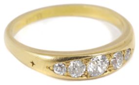 A Victorian five stone diamond set ring the stones graduating in size to either side, 18ct gold