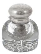 A Victorian heavy cut glass and silver topped inkwell hallmarked London 1886, with bulbous body