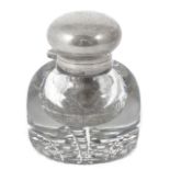 A Victorian heavy cut glass and silver topped inkwell hallmarked London 1886, with bulbous body