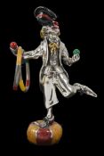 An Italian contemporary solid silver and enamel novelty clown figure in comedic pose stood on a ball