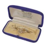 A delicate Edwardian pearl set brooch of floral design, with safety chain, cased. Measures 5.
