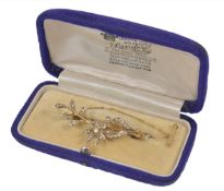 A delicate Edwardian pearl set brooch of floral design, with safety chain, cased. Measures 5.