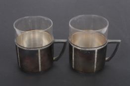 A pair of WMF silver plate and glass mugs the clear glass liners in simplistic holders with plain