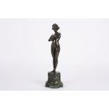 Paul Phillippe (20th century) French A bronze figure of a nude woman, stood with arms crossed on a