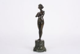 Paul Phillippe (20th century) French A bronze figure of a nude woman, stood with arms crossed on a