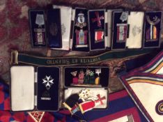 A collection of early 20th Century and later Masonic regalia including aprons, sashes and a