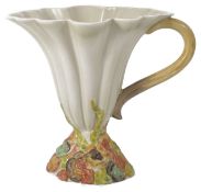 A Clarice Cliff Hollyhocks fluted jug the cream body of tapering form with scrolled handle and