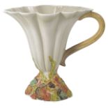 A Clarice Cliff Hollyhocks fluted jug the cream body of tapering form with scrolled handle and