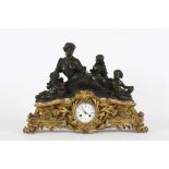 A large French bronze and gilt metal mantle clock circa 1850, surmounted by a figural group of a