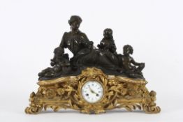 A large French bronze and gilt metal mantle clock circa 1850, surmounted by a figural group of a