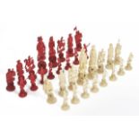 A Chinese late 19th century carved and stained ivory red and white puzzle ball chess set carved as