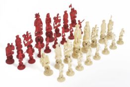 A Chinese late 19th century carved and stained ivory red and white puzzle ball chess set carved as