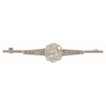 A late Victorian/Edwardian diamond set cluster brooch having a central old cut diamond cluster