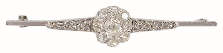 A late Victorian/Edwardian diamond set cluster brooch having a central old cut diamond cluster