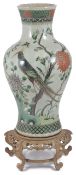 A large early 20th century Chinese famille verte baluster vase decorated with a bird of paradise