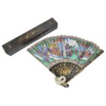 A 19th century Chinese Canton black lacquer and painted fan in case the front brightly and crisply