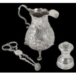 A George III embossed silver cream jug hallmarked London c.1776, with scrolled handle and