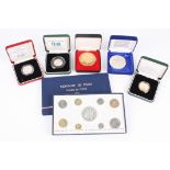 A collection of assorted commemorative and proof coins including Monnaie de Paris 1974, Chinese