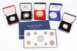 A collection of assorted commemorative and proof coins including Monnaie de Paris 1974, Chinese