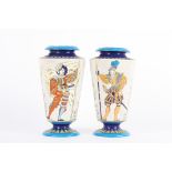 A pair of Boch Freres style pottery vases decorated with full-length stylised polychrome portraits