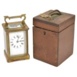 A 19th century brass striking carriage clock with white enamel dial and black Roman numerals,