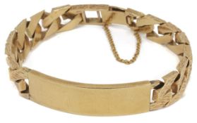 A heavy 9ct gold gentleman's Identity bracelet of flat curb link design with bark effect finish.