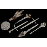 A collection of five silver Scottish dirk brooches a silver mounted rabbit foot brooch, together