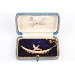 An Edwardian pearl set swallow upon a crescent brooch, marked 9ct to the reverse, with safety