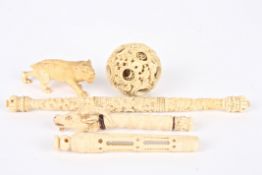 A small collection of early 20th century carved ivory and bone items including an ivory puzzle ball,