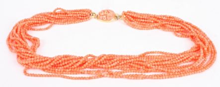 A multi strand coral bead twist choker, the salmon pink beads of even size with 18ct gold mounted