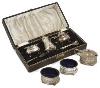 A silver cased cruet set together with an uncased example with pierced acanthus leaf decoration