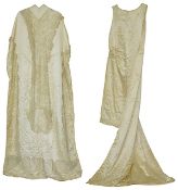 A 1920's wedding dress of ivory silk satin, complete with long shoulder train embroidered with