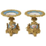 A pair of French Sevres style porcelain and ormolu tazza the power blue porcelain painted dishes