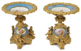 A pair of French Sevres style porcelain and ormolu tazza the power blue porcelain painted dishes