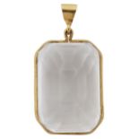 A large natural rock crystal emerald cut pendant with yellow metal mount and hanging loop. length