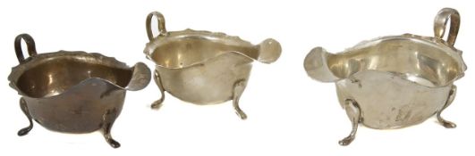 Three silver sauce boats of varying sizes, hallmarked Sheffield two dated 1947, the other 1933,