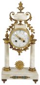 A late 19th century French marble and ormolu mantel clock the drum shaped case with white enamel