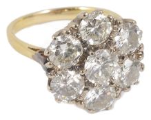 A large seven stone diamond circular cluster dress ring, the stones approx. weight 0.50ct each,